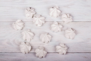 Fototapeta na wymiar merengues on white wooden background