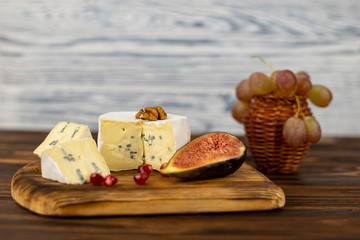 Cheese with a mold and a fig half