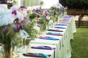 Green and pastel colorful table decor at a summer wedding reception