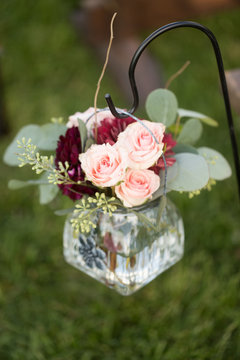 Close Up Of Wedding Flowers In Jar Hanging On Shepherd's Hook