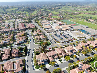 Aerial view suburban neighborhood with identical wealthy villas next to each other. San Diego, California, USA. Aerial view of residential modern subdivision luxury house with swimming pool.