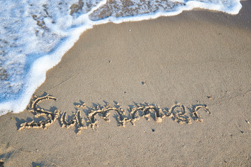 Summer message on the beach sand - vacation and travel concep