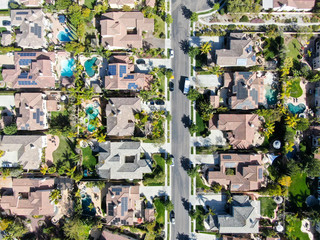 Aerial view suburban neighborhood with identical wealthy villas next to each other. San Diego,...
