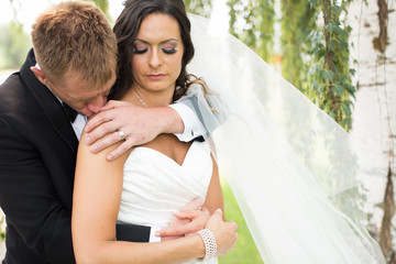 groom sensually kissing brides shoulder