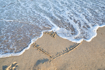 Love message on the beach sand - vacation and travel concep