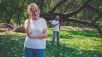 Senior woman feeling depressed after having a argument with her husband outdoor