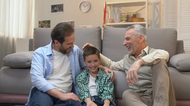 Happy grandfather enjoying pastime with his son and grandson, slow-motion