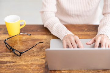 Fototapeta premium ラップトップコンピューターを見るシニア女性 手元