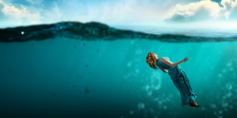 Woman dancer in clear blue water