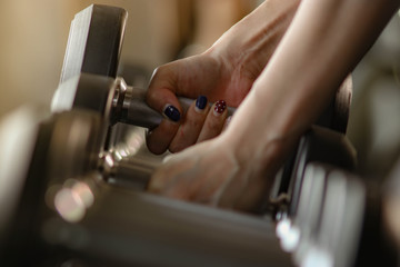Women who exercise builds muscles with dumbbell.