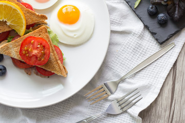Breakfast - Sandwich with ham and tomatoes on plate