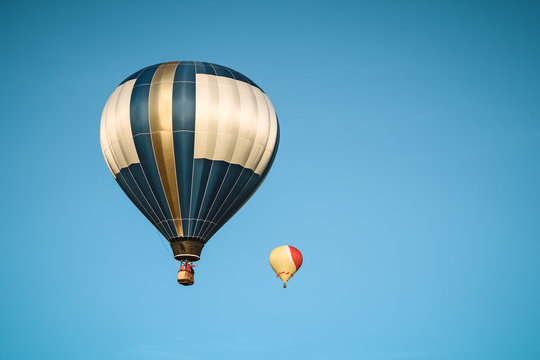 Two hot air balloons in the clear sky