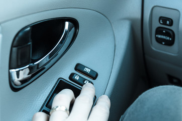 Obraz premium Closeup of hand touching button for locking car doors