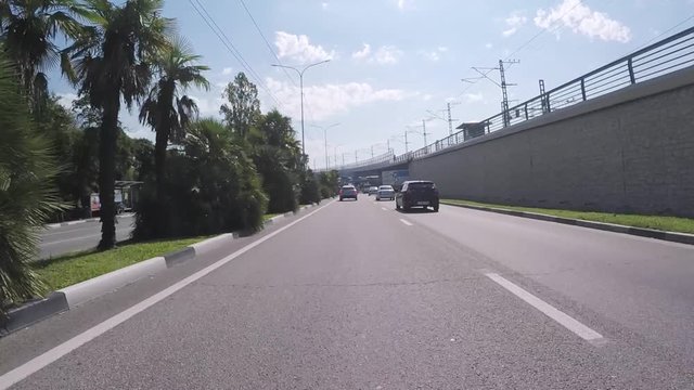 View from the motorcar on a road in Sochi near the railways. Scene. Krasnodar region, Russia.