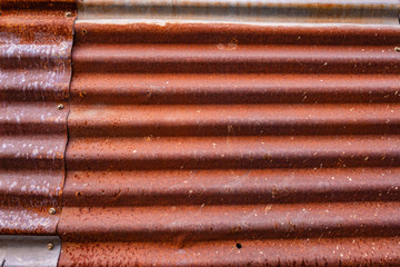 Abstract background surface of grunge rusty aged zinc metal roof sheet texture.