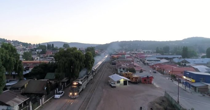 Aerial rolling shot of the El Chepe passenger train in Creel, Chihuahua, Mexico