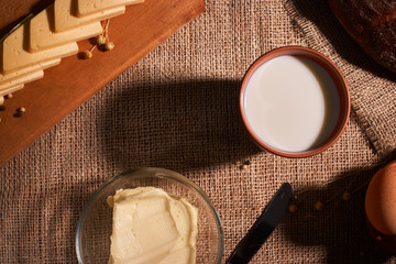 Assorted dairy products milk, cheese, butter rustic still life on table