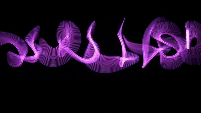 Pink light painting, long exposure photography, abstract swirls and waves against a black background