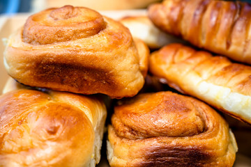 Fragrant homemade buns and pastries laid out in wooden plate