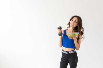 Healthy lifestyle, people and sport concept - Portrait of a healthy woman with vegetables and dumbbells