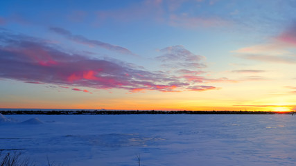 Beautiful Sunset and Pink clouds over frozen lake
