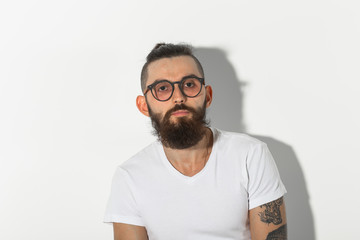 Beauty, fashion and people concept - Hipster man with beard posing over white background
