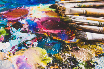 Color fragments stained on paper sheets from art and paint brushes