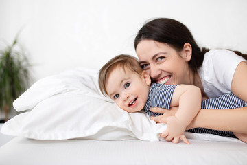 mother and baby boy on bed