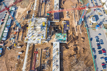 aerial view of building construction site with tower cranes