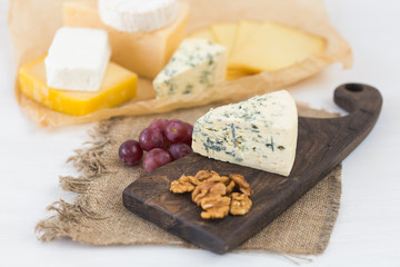 Cheese party table, perfect holiday appetizer with nut on rustic wooden board