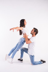Young couple dancing social latin dance bachata, merengue, salsa. Two elegance pose on white...