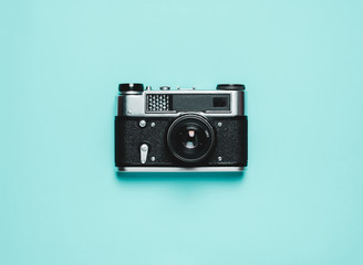Fototapeta premium old Vintage photo camera on a blue background