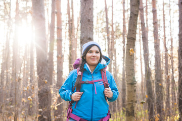 adventure, travel, tourism, hike and people concept - Attractive smiling tourist woman walking in...