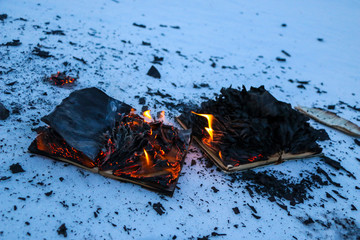 burning book in  snow. pages with the text in  open book burn with  bright flame.