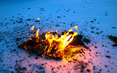 burning book in  snow. pages with the text in  open book burn with  bright flame.