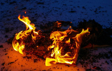 burning book in  snow. pages with the text in  open book burn with  bright flame.