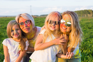 Festival of holi, people concept - Group of young people having fun outdoors