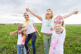 Family, festival of holi and holidays concept - portrait of happy family covered in paint