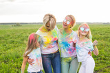 Family, festival of holi and holidays concept - portrait of happy family covered in paint