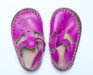 Purple leather baby sandals on a white background.