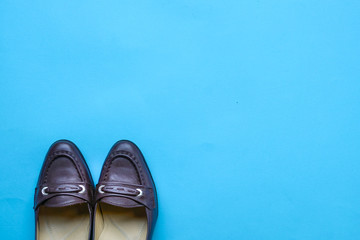 Brown women shoes on blue background