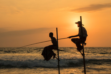 silhouette of fisherman at sunset on Koggala Beach Sri Lanka