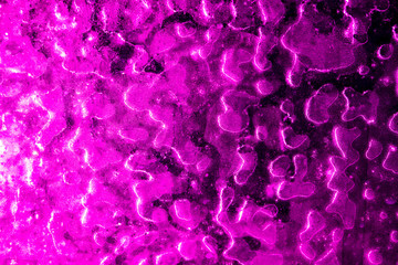 Ice on pink glass as abstract background