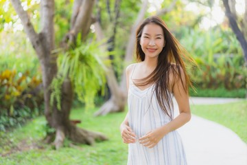 Fototapeta premium Portrait beautiful young asian woman walk with smile happy and relax in the park