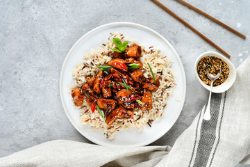 teriyaki chicken's  with chili pepper and sesame seeds, with rice. on a white plate, copy space, selective focus, Asian cuisine, Chinese cuisine, Thai cuisine. food flat lay. light background