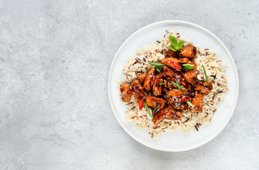 teriyaki chicken's  with chili pepper and sesame seeds, with rice. on a white plate, copy space, selective focus, Asian cuisine, Chinese cuisine, Thai cuisine. food flat lay. light background