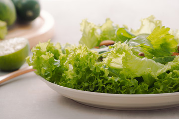 Mix of green fruits and vegetables on rustic wooden background