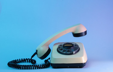 Old style rotary telephone with soaring telephone handle, neon light, 80s