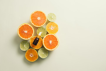 Brown Bottle with lemon, orange, tangerine and vitamin C. on white background.