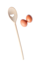eggs and wooden spoon isolated on white background